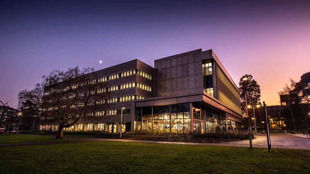 Smart modern building silhouetted against an evening sky of rich purple fading to orange