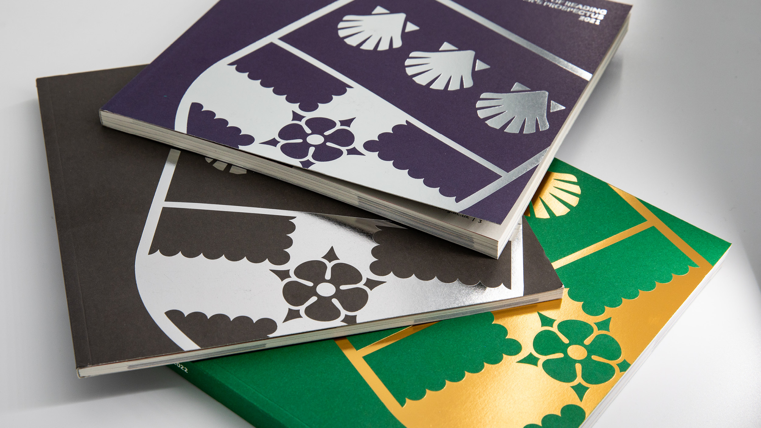 Pile of prospectuses in green, purple and black