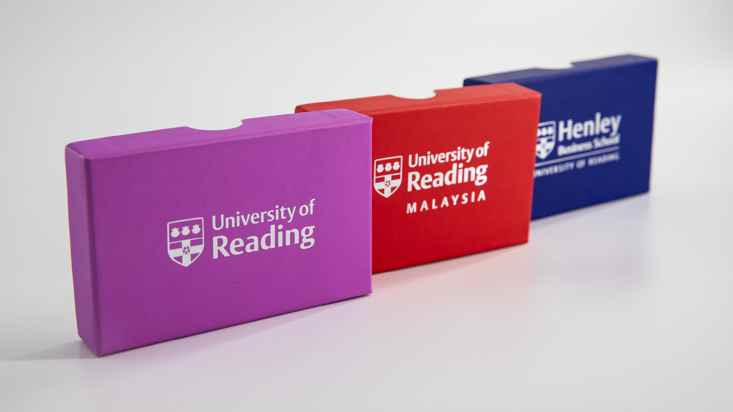 Celebratory pins in purple, red and blue boxes