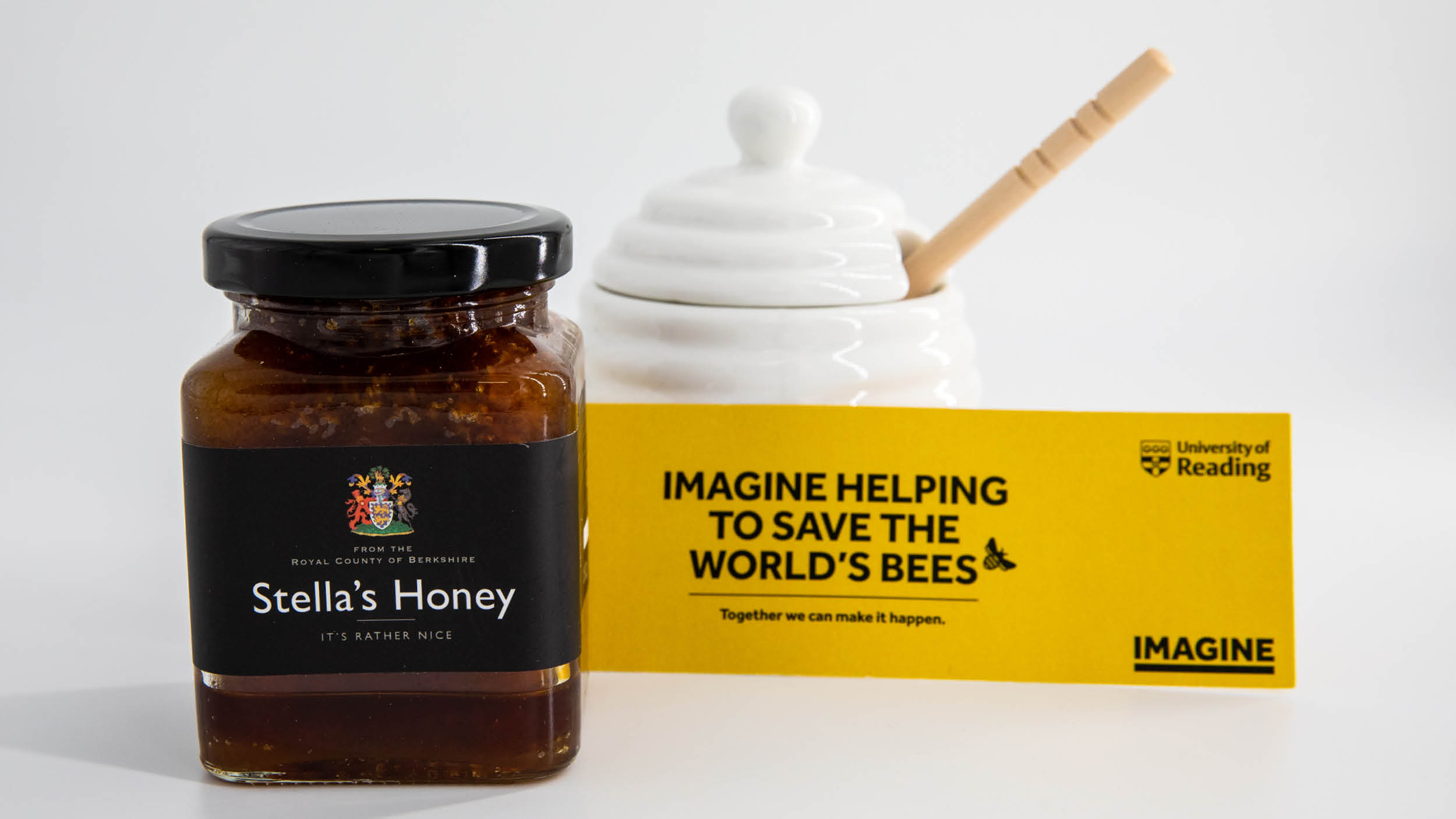 Bespoke honey set corporate gift featuring a jar of honey, a pot with stirrer and a card about the University's research into bees