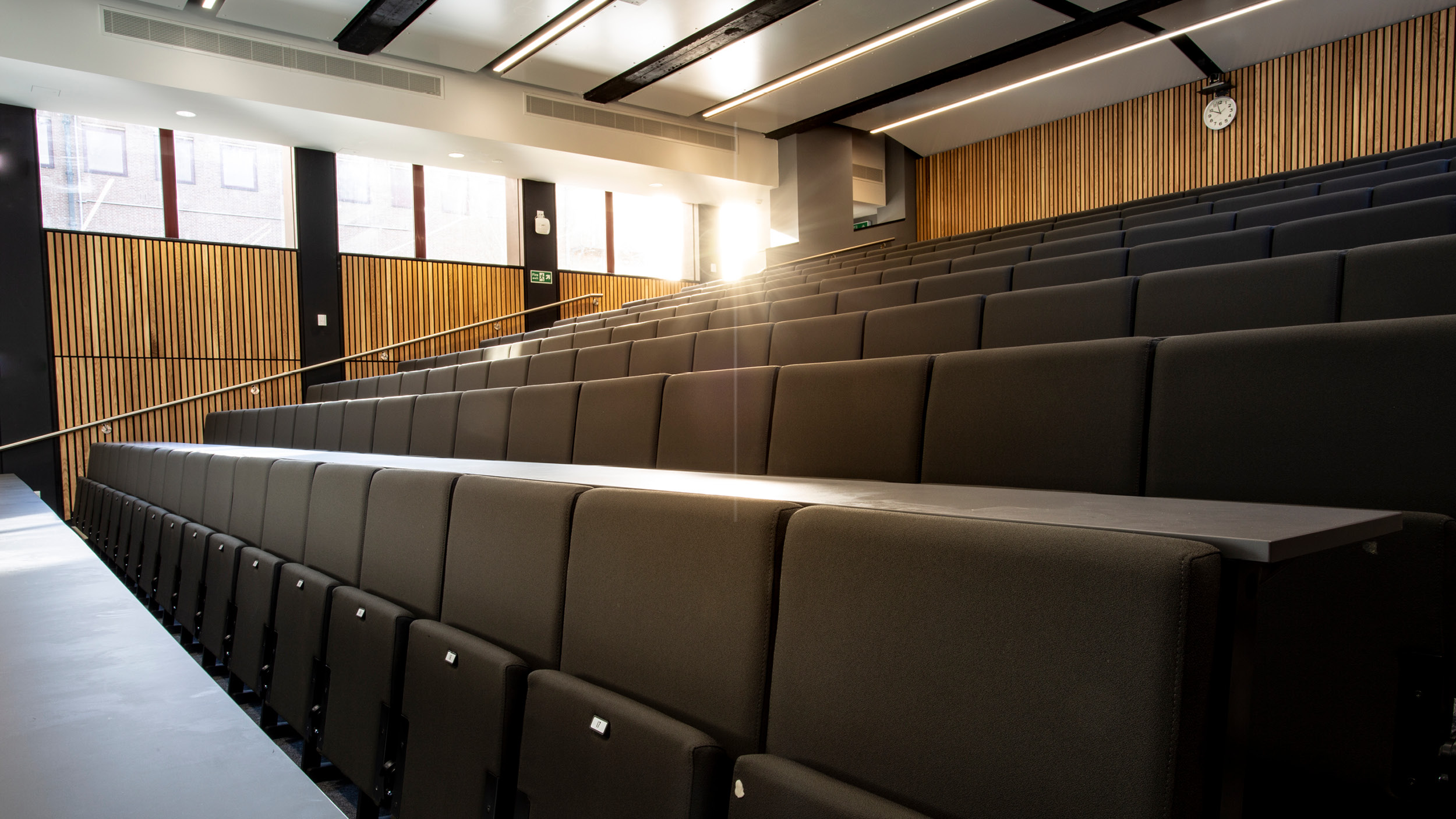 Smart modern lecture theatre with rows of fold down seats