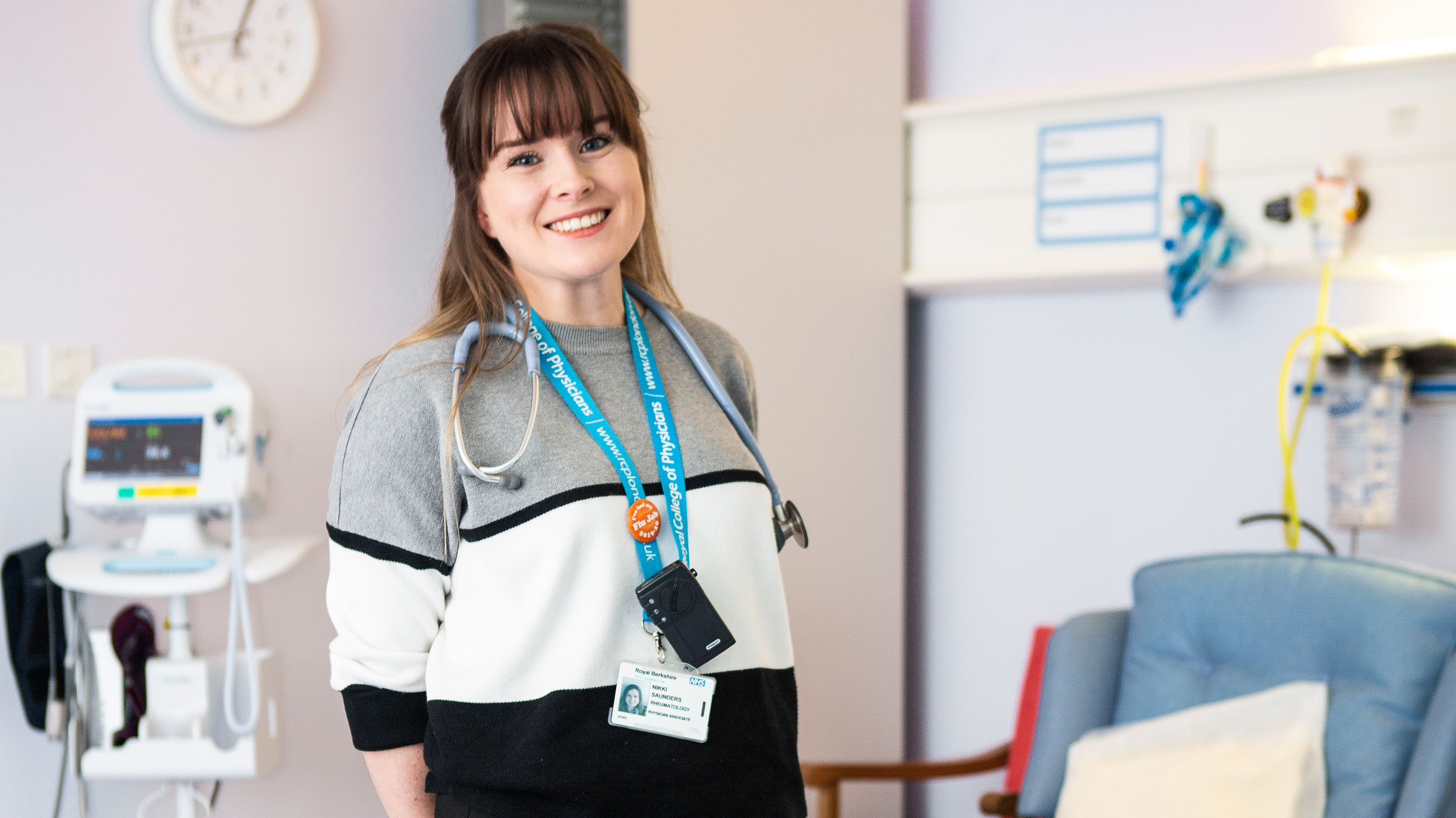Young woman on Physician Associates programme stands in hospital environment