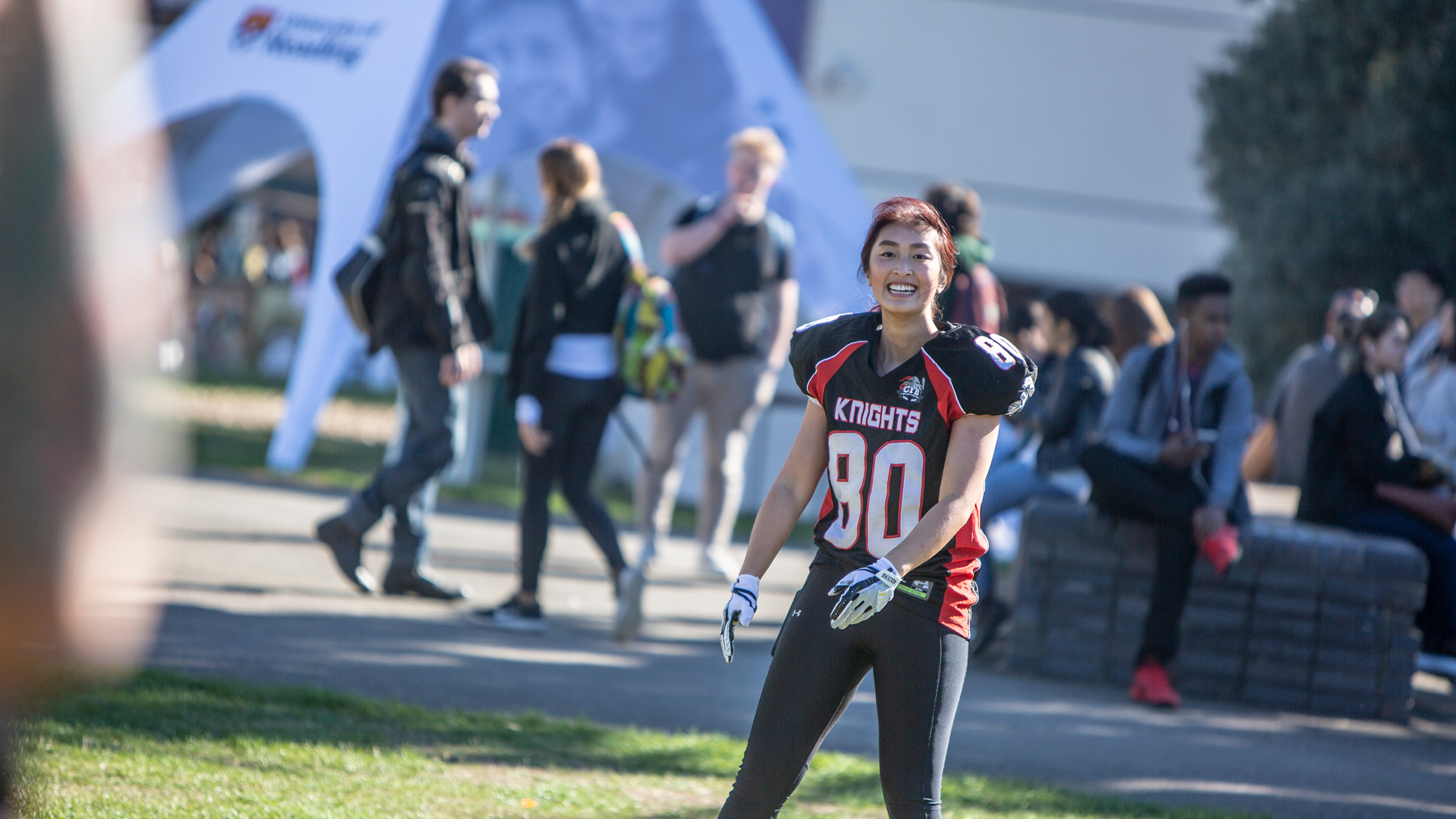 Female student playing sports on the quad during freshers week