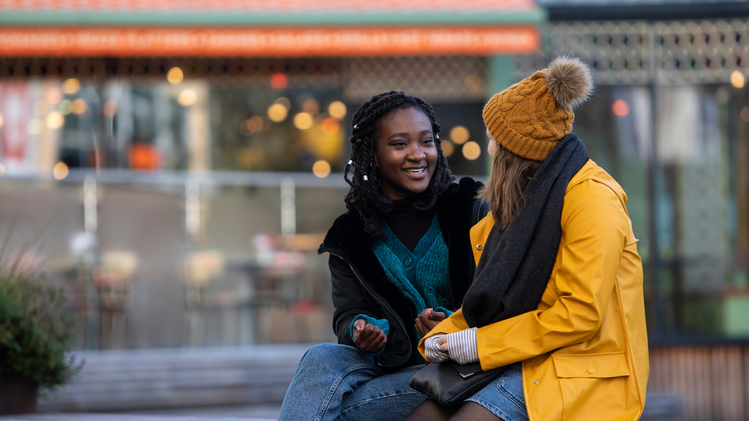 Two female students socialising outside at the Oracle Riverside