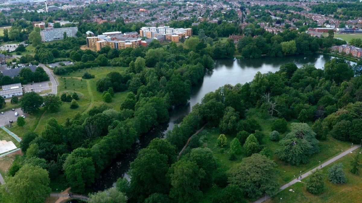 Aerial view of Whiteknights lake and green campus, the University of Reading,