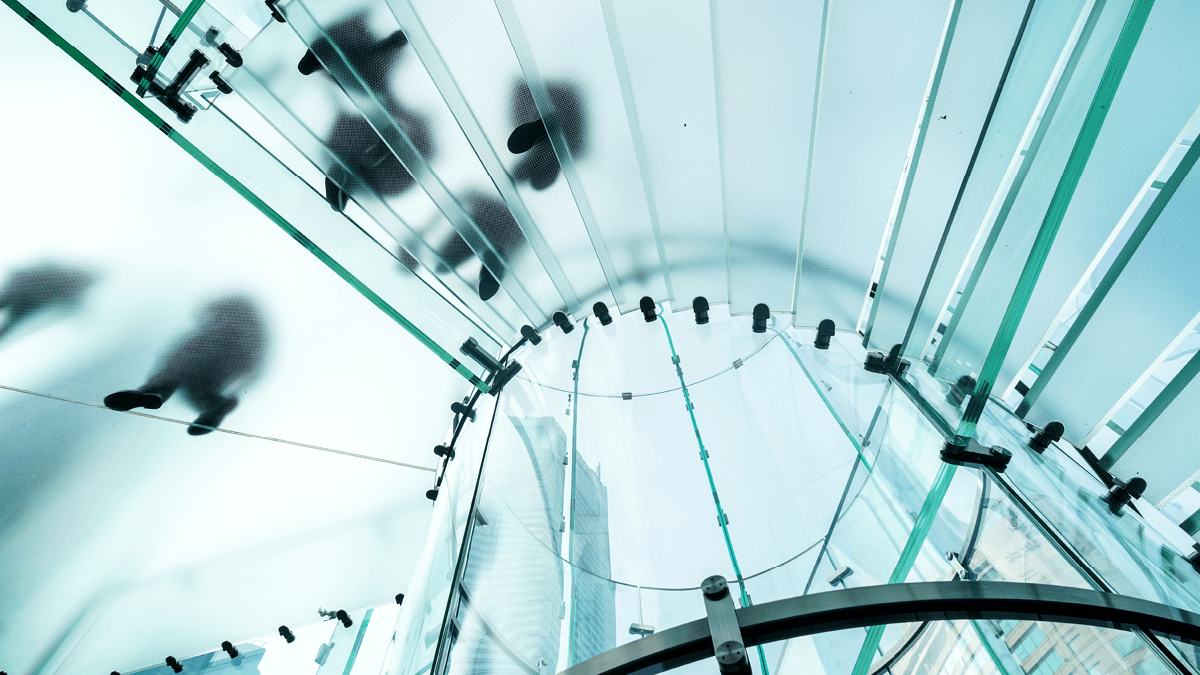 People are walking on the modern transparent staircase 
